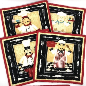 May include: Set of four red and black quilted pot holders featuring a cartoon chef in different poses. Each pot holder has a black and white checkered background and a variety of kitchen utensils around the border.