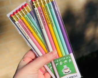 May include: Two packs of #2 pencils with phrases from the TV show Friends. Each pencil is a different pastel color and has a quote like "Pivot" or "I'll be there for you." The packaging features the Central Perk logo.