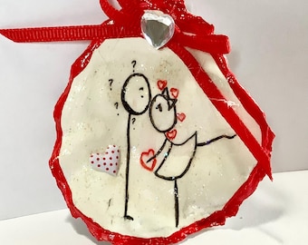 Adorno de concha de ostra con forma de pareja de palitos