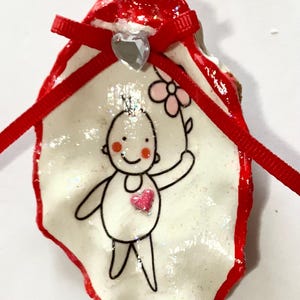 Baby With Flower Oyster Shell Ornament