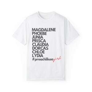 May include: White t-shirt with black text that reads "Magdalene, Phoebe, Junia, Prisca, Claudia, Dorcas, Chloe, Lydia" and "#preachlikegirl" in red text.