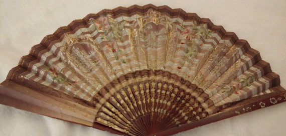 Antique hand fan hand painted. Detailed with gold