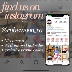 May include: A mobile phone screen displaying a social media page for a business called Ruby Moon. The page features a logo with a red moon and the text "Ruby Moon". The page also includes information about the business, such as its location, contact information, and a link to its website. The page also includes a call to action to follow the business on Instagram. The text "find us on instagram @rubymoon_xo" is displayed above the phone screen. Below the phone screen, the text "Giveaways, $5 damaged hat sales, exclusive promo codes" is displayed.