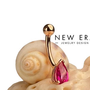 14 karat gold ruby belly button ring. Pear-shaped navel ring. Ruby body jewelry curved barbell.