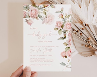 May include: A white rectangular baby shower invitation card featuring watercolor illustrations of pink roses and green leaves along the top and right edges. The text reads: A SWEET baby girl IS ON THE WAY, PLEASE JOIN US AS WE HONOR MOMMY-TO-BE, Jennifer Smith, SATURDAY, OCTOBER 8TH AT 2:00PM, THE SMITHS' RESIDENCE, 17 STONEBRIDGE WAY | MORRISON, CO, RSVP by 9/23 TO LINDA @ 123-456-7890, registered at target and amazon.