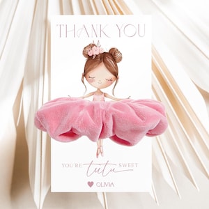 May include: A thank you card with a ballerina illustration. The card says "THANK YOU" at the top and "You're tutu sweet Olivia" at the bottom. The ballerina has brown hair and a pink tutu. The card is decorated with a pink heart.