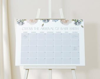 May include: A rectangular sign featuring a calendar grid with the text GUESS THE ARRIVAL OF BABY SMITH at the top. The design includes watercolor floral illustrations in shades of blue, green, and cream along the upper edge.