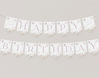 May include: A two-row white pennant banner spelling HAPPY BIRTHDAY with dusty rose lettering. Each flag features a floral and butterfly illustration at the bottom. The end flags display the text OLIVIA'S fairy first in a script font.