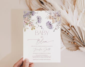 May include: A rectangular baby shower invitation card featuring a watercolor floral design in shades of purple, yellow, and green at the top. The text reads BABY in Bloom, JOIN US FOR A BABY SHOWER IN HONOR OF Jennifer Smith, SATURDAY, OCTOBER 8TH AT 2:00PM, THE SMITHS RESIDENCE, 17 STONEBRIDGE WAY | MORRISON, CO, RSVP BY 9/23 TO LINDA | 123-456-7890, registered at target and amazon.
