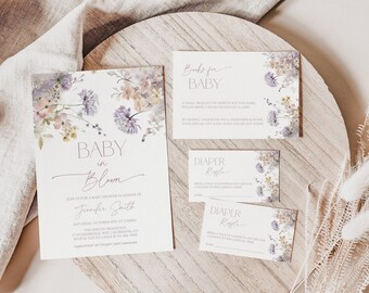 May include: A set of white paper stationery featuring floral illustrations in purple, yellow, and green. The cards include text reading Baby in Bloom, Books for Baby, and Diaper Raffle, with details for a baby shower event for Jennifer Smith.