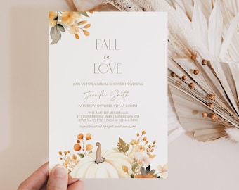 May include: A white bridal shower invitation card featuring watercolor illustrations of orange and yellow autumn leaves and a pumpkin. The text reads: FALL in LOVE, JOIN US FOR A BRIDAL SHOWER HONORING Jennifer Smith, SATURDAY, OCTOBER 8TH AT 2:00PM, THE SMITHS' RESIDENCE, 17 STONEBRIDGE WAY | MORRISON, CO, RSVP BY 9/23 TO LINDA @ 123-456-7890, registered at target and amazon.