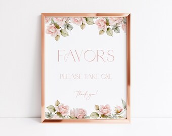 May include: A framed sign with the word "FAVORS" in a delicate font, with the text "PLEASE TAKE ONE" and "Thank you!" below. The sign is decorated with watercolor roses and greenery, and framed in a rose gold colour.
