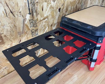 May include: A black metal tool organizer with a folding tray. The tray is attached to a red toolbox with a black top.