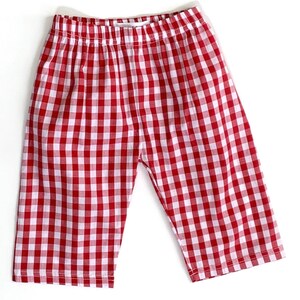 May include: Red and white gingham checkered shorts with an elastic waistband.