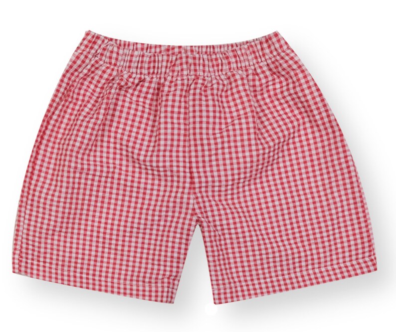 May include: Red and white gingham shorts with an elastic waistband.