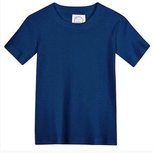 May include: A solid navy blue short-sleeve t-shirt with a crew neckline. The garment features a white interior neck label with the letters BB printed in a circular gold and blue logo design, centered at the inner collar of the plain blue shirt.