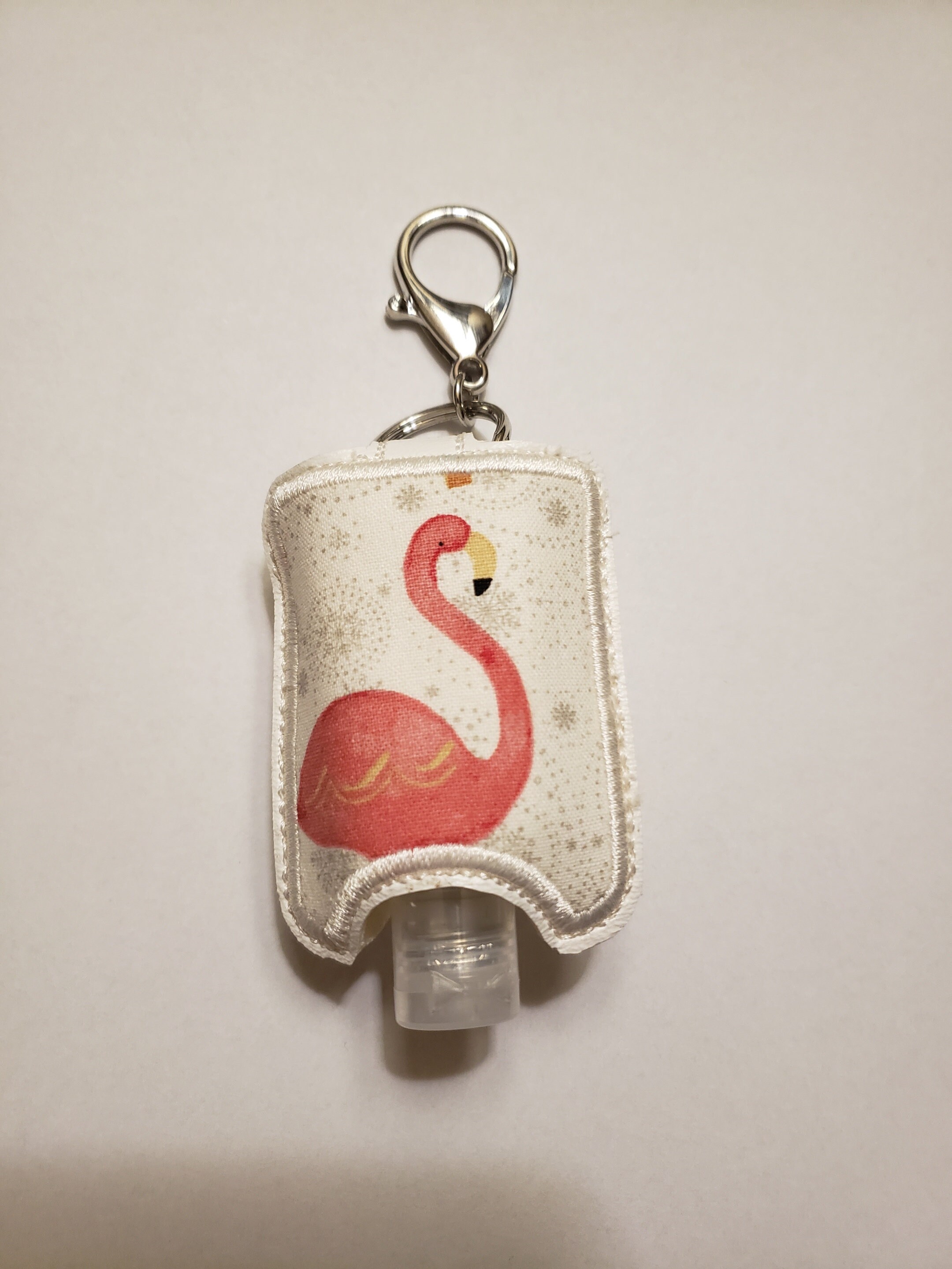 Snap back keychain sanitizer holders