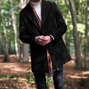 May include: A black corduroy double-breasted coat with a white turtleneck sweater and a plaid scarf.