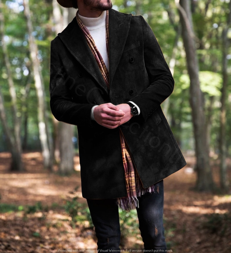 May include: A black corduroy double-breasted coat with a white turtleneck sweater and a plaid scarf.
