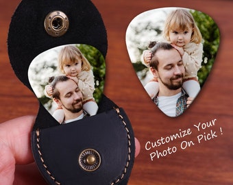 May include: A black leather guitar pick holder with a snap closure, holding a guitar pick with a photo of a man and child. The text "Customize Your Photo On Pick!" is visible.