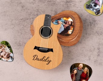 May include: A wooden acoustic guitar-shaped box with a photo of a couple inside. The guitar is engraved with the word "Daddy". The box comes with several guitar picks with photos of families on them.