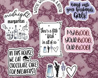 May include: A collection of seven die-cut vinyl stickers featuring black and purple text and illustrations. Designs include phrases like midnight margaritas, witch witch you're a bitch, hang onto your husbands girls, and in this house we eat chocolate cake.
