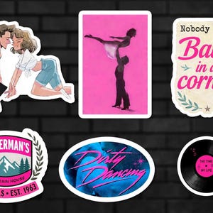 May include: A set of six stickers featuring Dirty Dancing themes: an illustrated couple, a silhouette of a lift on a pink background, a quote reading "Nobody puts Baby in a corner," a Kellerman's Mountain House logo, a blue logo, and a vinyl record.