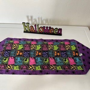 Halloween Table Runner - Multi bright colors with Witches/Bats/Haunted houses. Purple spider backing