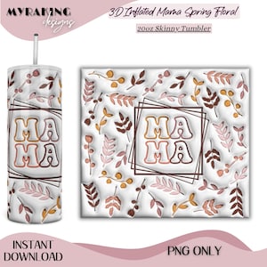 May include: A 20oz skinny tumbler with a floral design and the word "MAMA" in a square frame. The tumbler is white with a straw and features a repeating pattern of leaves and flowers in shades of brown, pink, and yellow.