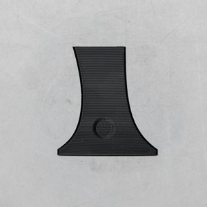 May include: A black plastic base with a rounded opening in the center. The base is designed to hold a small object, such as a candle or a vase.
