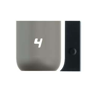 May include: A gray ceramic mug with the number "4" printed on the front. The mug is next to a black plastic lid with a small circle on the side.