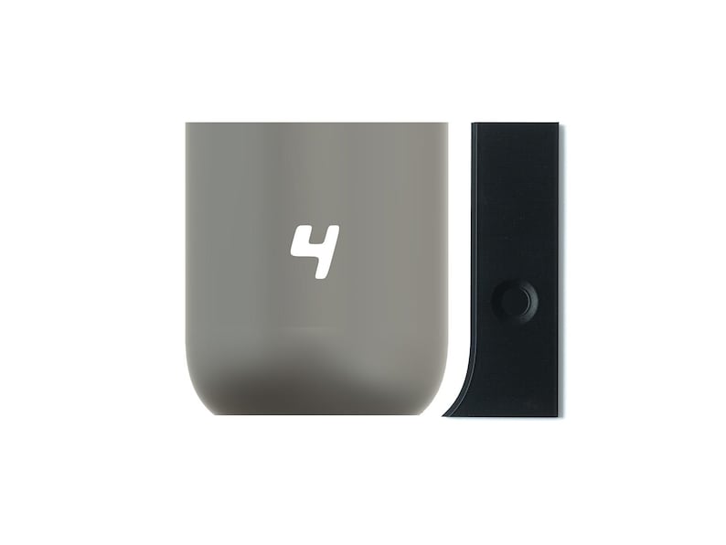 May include: A gray ceramic mug with the number "4" printed on the front. The mug is next to a black plastic lid with a small circle on the side.