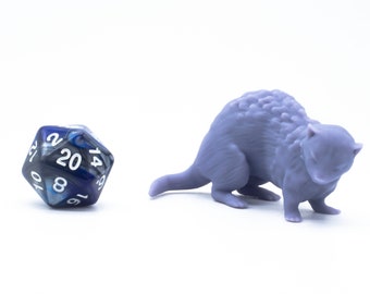 May include: A purple 3D printed miniature of a small furry creature with a long tail. The creature is curled up in a defensive position. A blue and silver 20-sided die is also in the image.