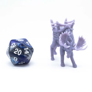 May include: A purple and blue 20-sided die with white numbers and a purple moose figurine with a saddle on its back.