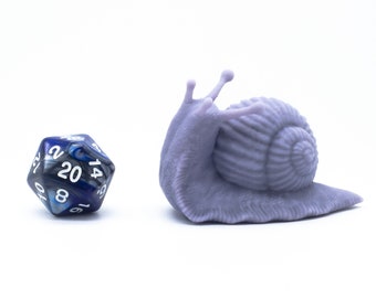 May include: A purple 3D printed snail figurine with a blue and silver 20-sided die.