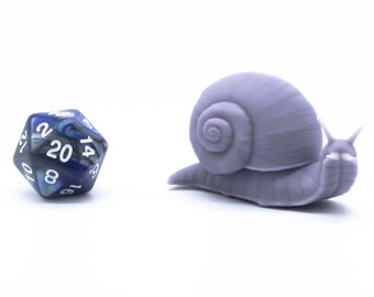 May include: A blue and silver 20-sided die with white numbers sits next to a purple 3D printed snail figurine.
