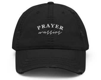 May include: Black distressed baseball cap with the words "PRAYER warrior" embroidered in white. The cap has a curved brim and a distressed, worn look.