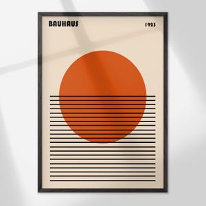 The image is a framed poster featuring a minimalist design with a large orange circle and horizontal black lines.