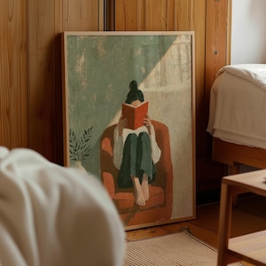 Może przedstawiać: Oprawiony wydruk artystyczny przedstawiający osobę z ciemnymi włosami upiętymi w kok, siedzącą w fotelu w kolorze rdzy i czytającą otwartą czerwoną książkę. Osoba ma na sobie białą bluzkę z długim rękawem oraz ciemnozielone spodnie. Po lewej roślina.