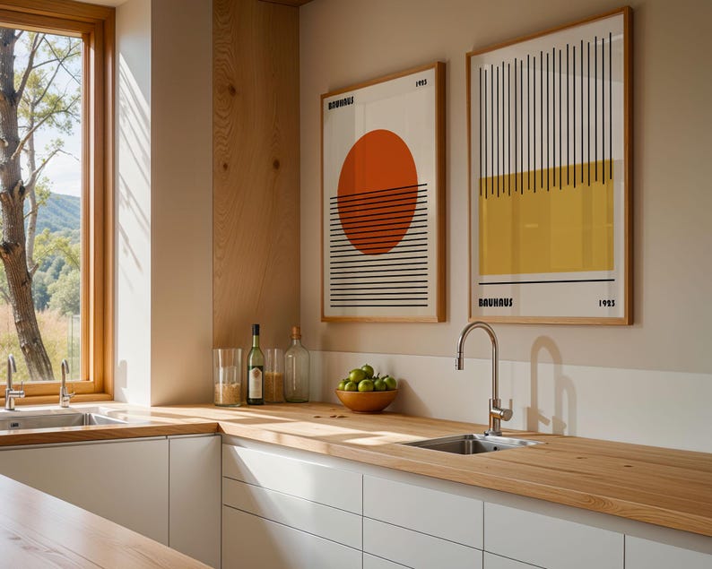 a modern kitchen with a wooden countertop, a sink, and two framed abstract artworks hanging on the wall.