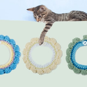 May include: Three crocheted cat collars in blue, yellow, and green with a button closure. The collars have a ruffled edge and are made with a variety of stitches.