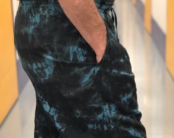 May include: Black and blue tie-dye pants with a drawstring waist.