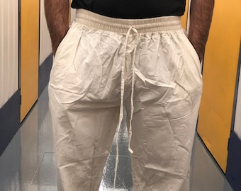 May include: A pair of loose-fitting, white cotton pants with a drawstring waist.