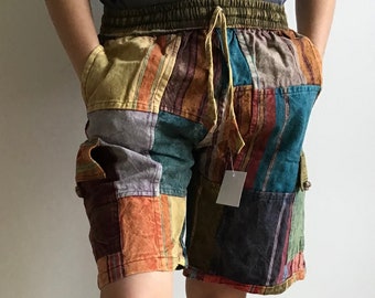 May include: Patchwork cargo shorts with a drawstring waist. The shorts are made of a variety of fabrics in different colors, including brown, blue, green, and yellow.