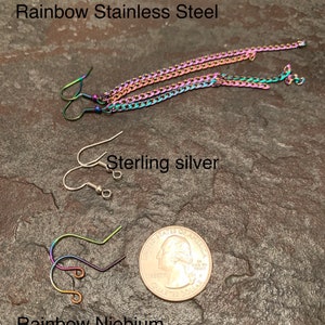 May include: Three pairs of earrings with different hook styles and finishes. The top pair is rainbow stainless steel, the middle pair is sterling silver, and the bottom pair is rainbow niobium.