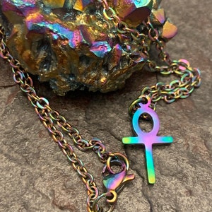 May include: A rainbow iridescent stainless steel chain necklace with an ankh pendant.