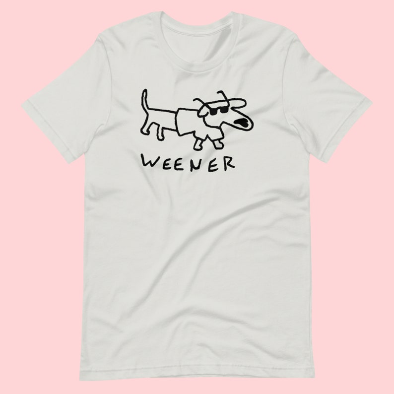 May include: White t-shirt featuring a black line drawing of a dachshund wearing sunglasses and the word "WEENER" underneath.
