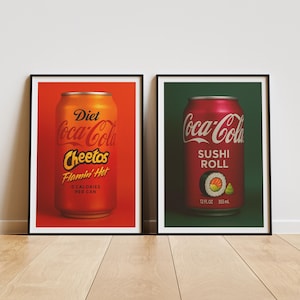 May include: Two Coca-Cola cans with different labels. The can on the left is red and orange and says "Diet Coca-Cola Cheetos Flamin' Hot 0 Calories Per Can". The can on the right is red and says "Coca-Cola Sushi Roll 12 fl oz 355 ml".