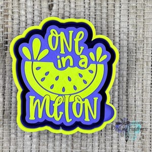 May include: A layered, colorful design featuring the phrase "ONE in a MELON" in a playful font. The design includes a slice of watermelon in bright green with black seeds, set against a blue and yellow background.