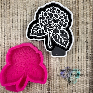 May include: A black and white hydrangea flower cookie cutter with a white outer frame and a black inner detail piece, alongside a matching bright pink silicone mold of the same hydrangea flower shape, featuring detailed petals and leaves.